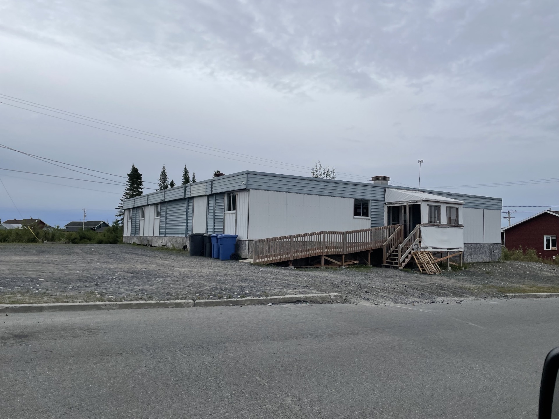 The current Victory Faith Church building in Mistissini — blue and grey siding.